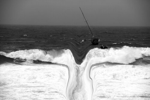 Fearful wave with a sailing boat José Antonio Castro-Muñiz